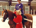 Linda working with a horse and rider